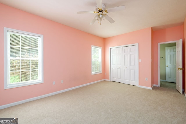 6391 Compass Dr, Flowery Branch, GA 30542 - unfurnished bedroom with light carpet, a closet, and a ceiling fan