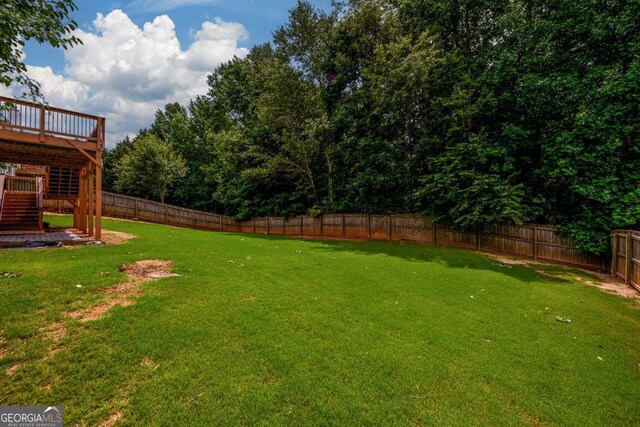 6391 Compass Dr, Flowery Branch, GA 30542 - fenced backyard featuring stairway and a wooden deck