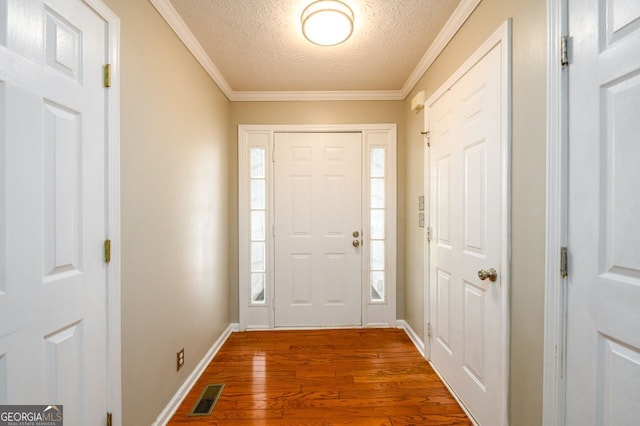 6391 Compass Dr, Flowery Branch, GA 30542 - entryway with a textured ceiling, wood finished floors, and crown molding