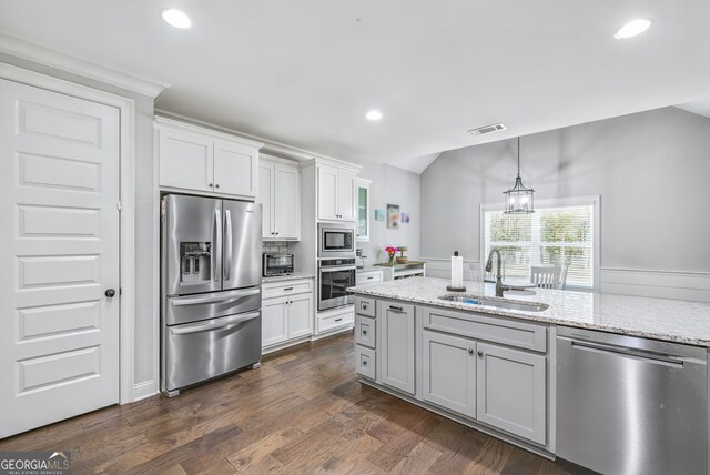 92 Gordon Oaks Way, Moreland, GA 30259 - kitchen with appliances with stainless steel finishes, a sink, vaulted ceiling, white cabinetry, and recessed lighting