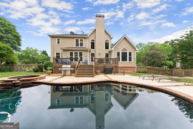 1721 Mulberry Lake Dr, Dacula, GA 30019 - back of house featuring a deck, an in-ground hot tub, a fenced backyard, a patio area, and stairway