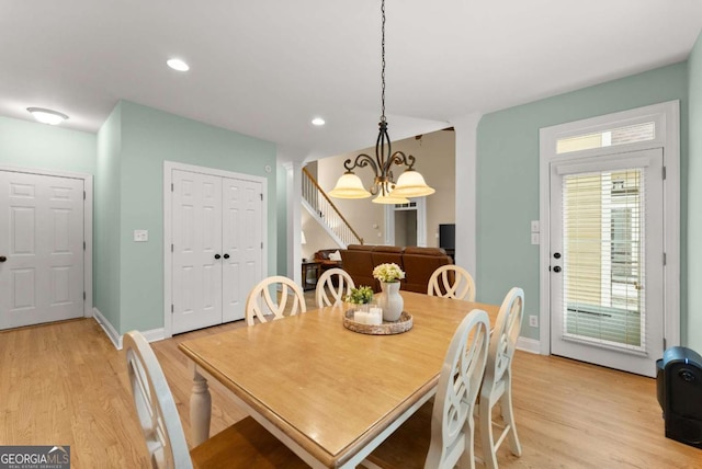 dining room with a chandelier, light wood finished floors, stairway, recessed lighting, and baseboards