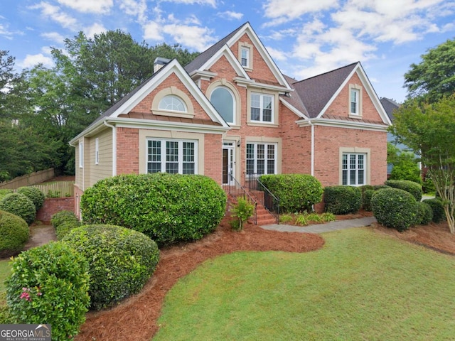 view of front facade featuring brick siding and a chimney