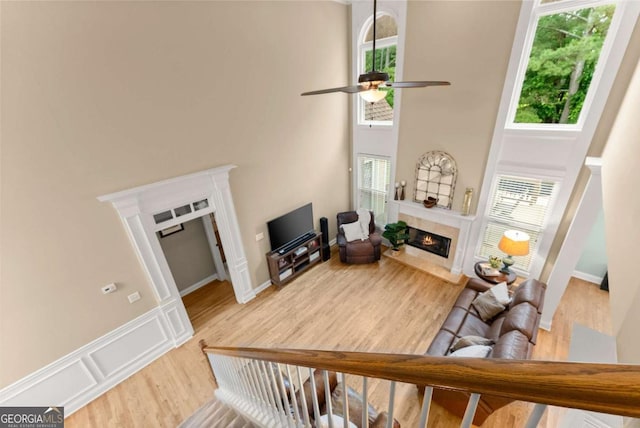 1721 Mulberry Lake Dr, Dacula, GA 30019 - living area featuring a fireplace, plenty of natural light, a towering ceiling, and wood finished floors