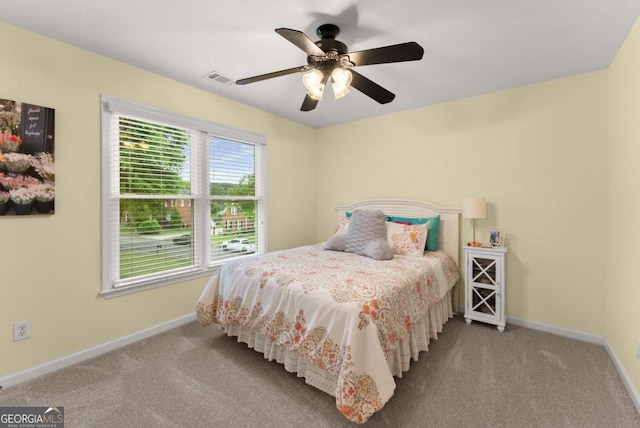 carpeted bedroom featuring baseboards and ceiling fan