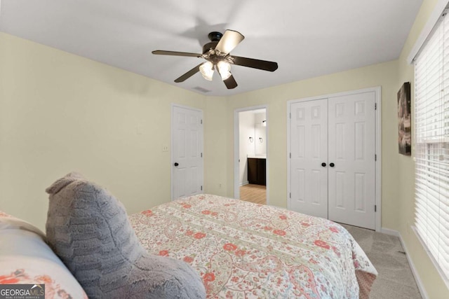 bedroom featuring a closet, light carpet, baseboards, and ceiling fan