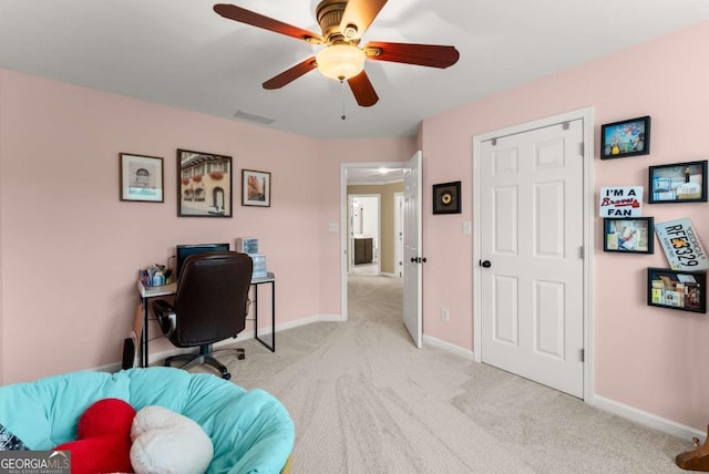 home office with ceiling fan, light colored carpet, and baseboards