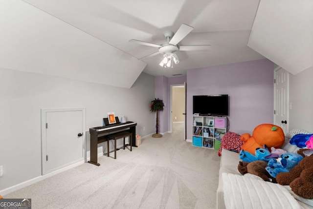 recreation room with vaulted ceiling, carpet, ceiling fan, and baseboards