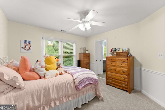 bedroom with light carpet and a ceiling fan