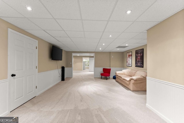 sitting room with wainscoting, carpet, and a paneled ceiling
