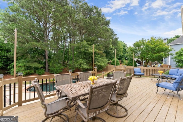 wooden deck featuring outdoor dining area