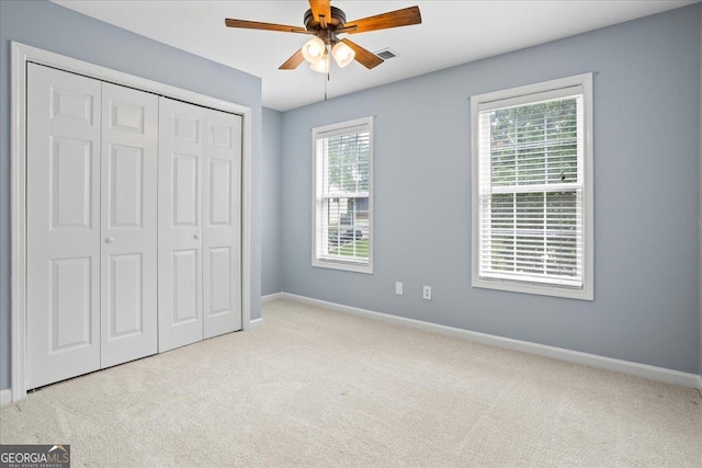 unfurnished bedroom with carpet, baseboards, and a closet