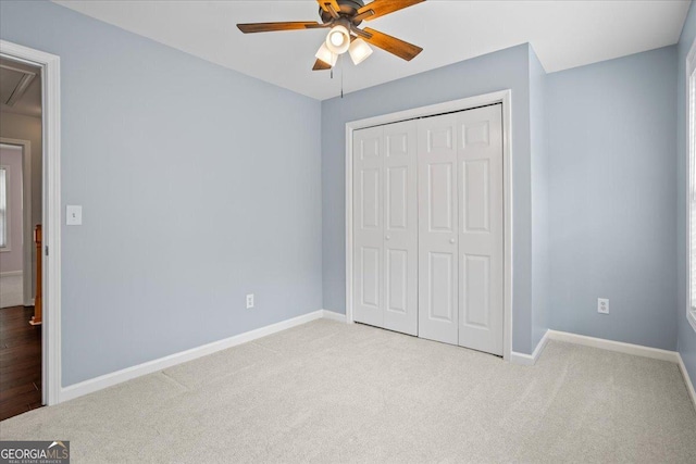 unfurnished bedroom featuring attic access, carpet floors, and baseboards