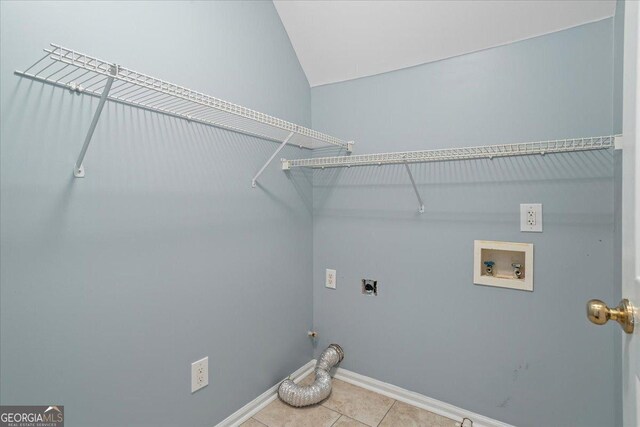 washroom featuring hookup for an electric dryer, washer hookup, baseboards, and light tile patterned floors