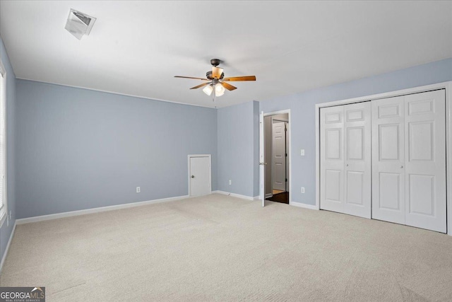 unfurnished bedroom with carpet flooring, baseboards, ceiling fan, and a closet