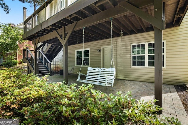 view of patio featuring stairway and a wooden deck
