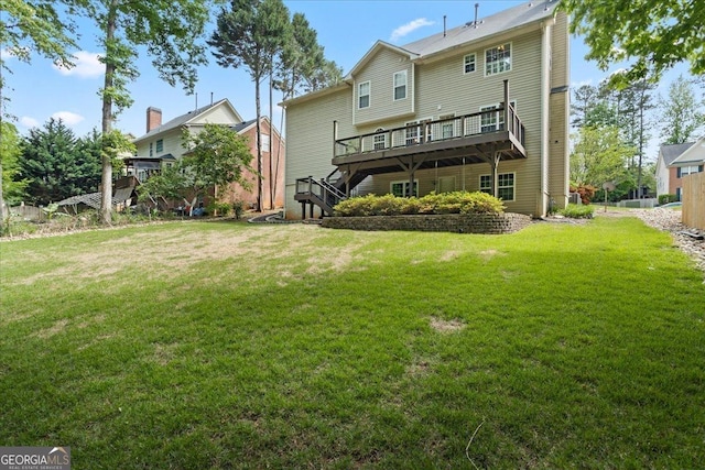 back of house with a deck, a lawn, and stairway