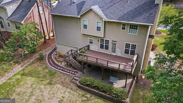 back of house featuring a deck, a yard, a patio area, stairway, and roof with shingles