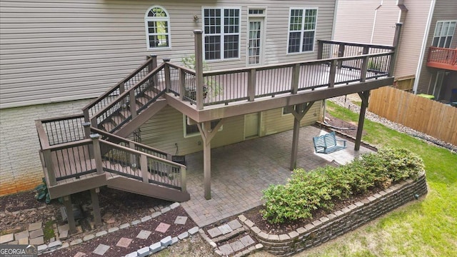 wooden deck with a patio area and fence