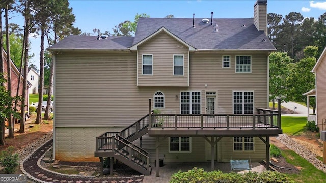 rear view of property with a wooden deck, stairway, a chimney, and a patio area