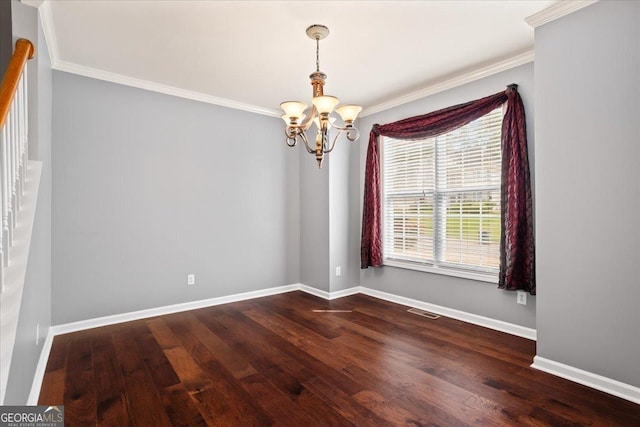 spare room with ornamental molding, a chandelier, dark wood finished floors, and baseboards