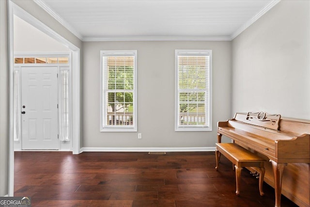 living area featuring ornamental molding, wood finished floors, and baseboards