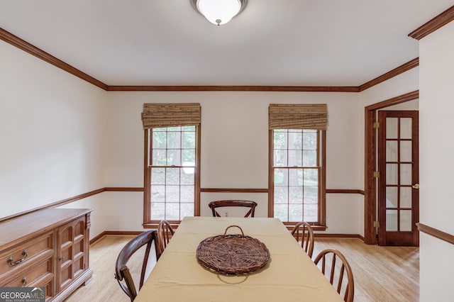3741 Windhurst Dr SW, Lilburn, GA 30047 - dining space with light wood-type flooring, healthy amount of natural light, baseboards, and ornamental molding