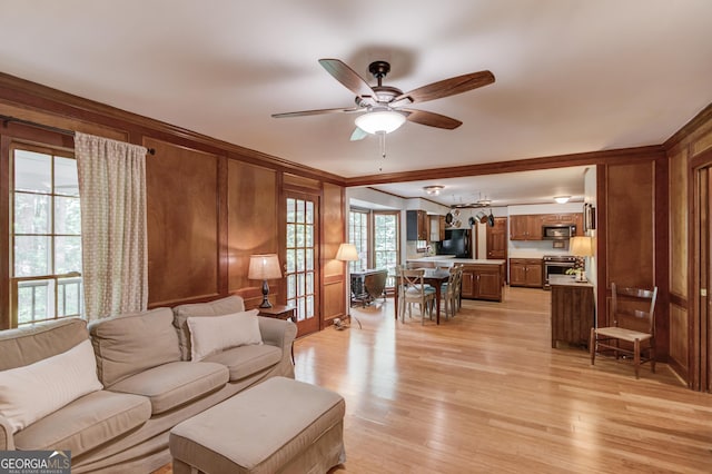 3741 Windhurst Dr SW, Lilburn, GA 30047 - living area featuring a ceiling fan, ornamental molding, light wood finished floors, and wooden walls