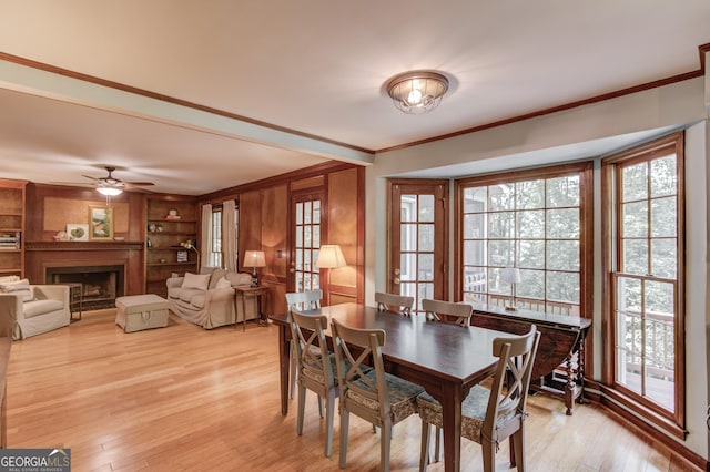 3741 Windhurst Dr SW, Lilburn, GA 30047 - dining room with ornamental molding, healthy amount of natural light, light wood-style floors, a ceiling fan, and a fireplace