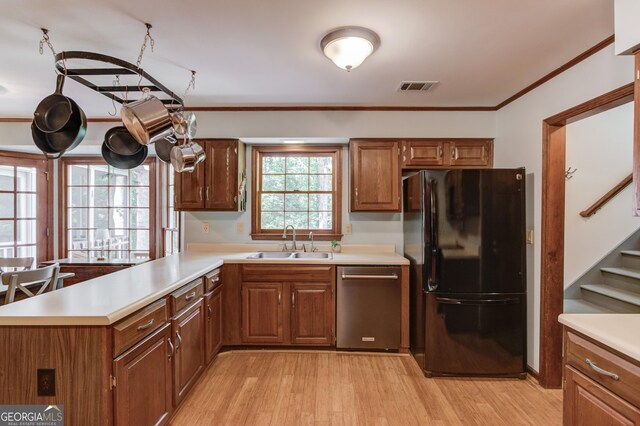 3741 Windhurst Dr SW, Lilburn, GA 30047 - kitchen featuring freestanding refrigerator, stainless steel dishwasher, a sink, light countertops, and a peninsula