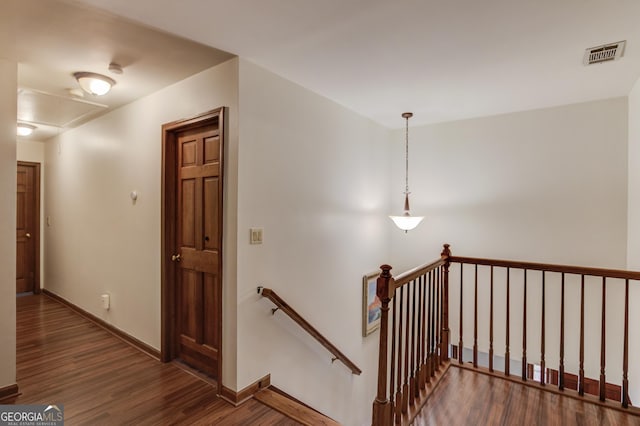3741 Windhurst Dr SW, Lilburn, GA 30047 - hallway with an upstairs landing, wood finished floors, baseboards, and attic access