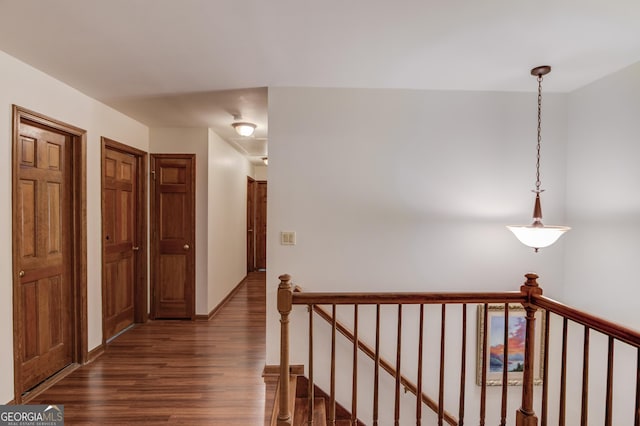 3741 Windhurst Dr SW, Lilburn, GA 30047 - hallway with an upstairs landing and dark wood finished floors