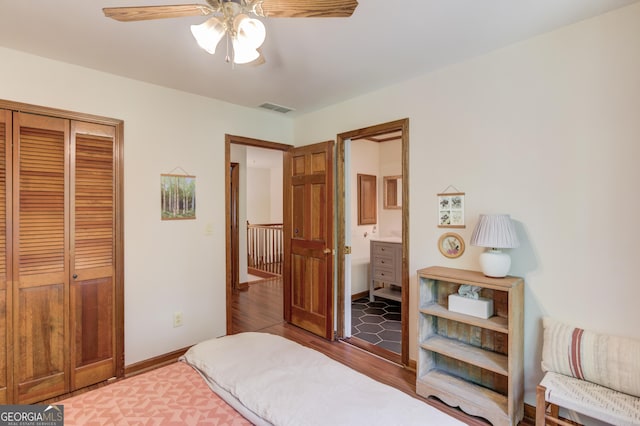 3741 Windhurst Dr SW, Lilburn, GA 30047 - bedroom with wood finished floors, a closet, ensuite bath, baseboards, and a ceiling fan