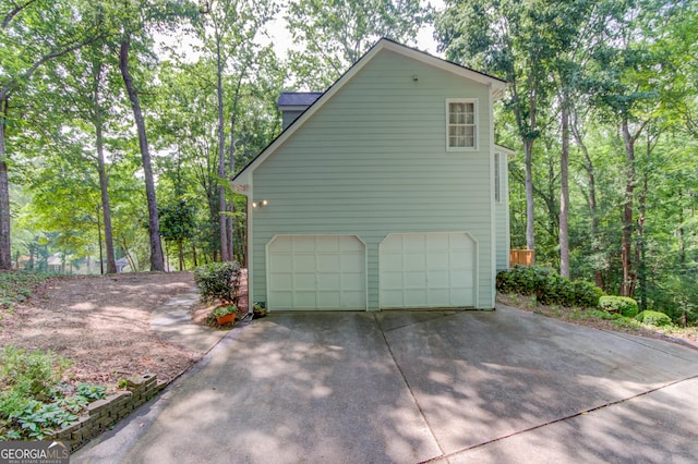 3741 Windhurst Dr SW, Lilburn, GA 30047 - view of property exterior with concrete driveway and a garage