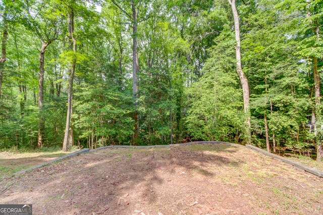 3741 Windhurst Dr SW, Lilburn, GA 30047 - view of yard with a wooded view