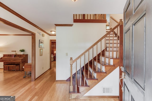 3741 Windhurst Dr SW, Lilburn, GA 30047 - stairs with baseboards, wood finished floors, and ornamental molding