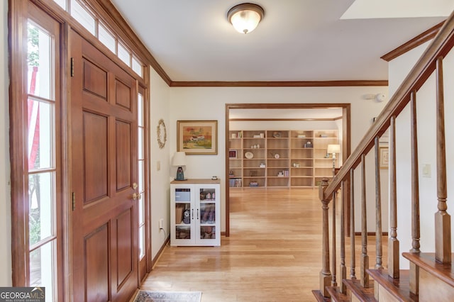 3741 Windhurst Dr SW, Lilburn, GA 30047 - entrance foyer with ornamental molding, light wood-type flooring, and stairway