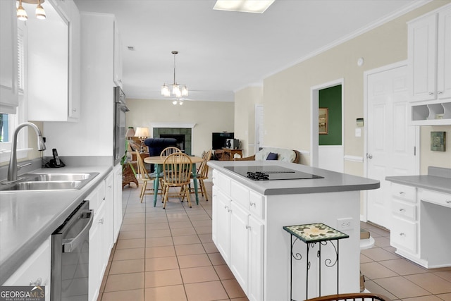 kitchen with a sink, light tile patterned floors, black appliances, white cabinets, and a center island