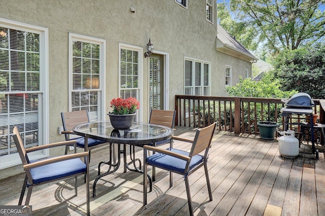 wooden deck featuring outdoor dining space and grilling area