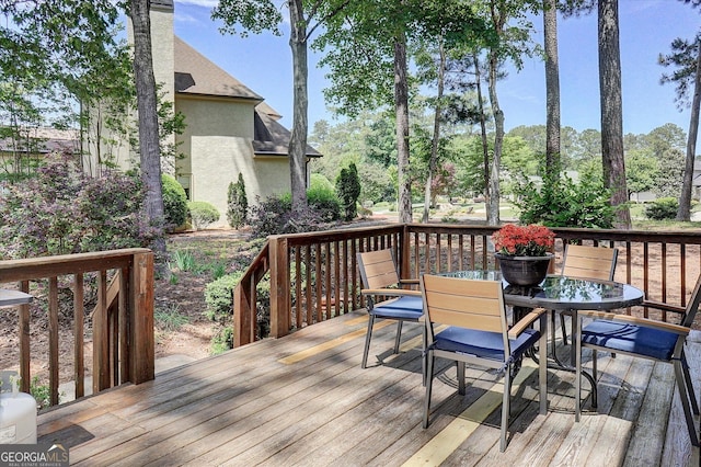wooden deck featuring outdoor dining area