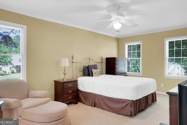 bedroom featuring light colored carpet, multiple windows, ornamental molding, and ceiling fan