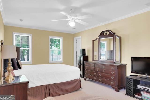 bedroom featuring carpet flooring, ornamental molding, and a ceiling fan