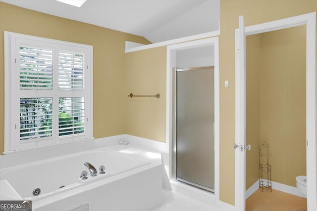 full bath featuring a stall shower, a tub with jets, toilet, tile patterned flooring, and vaulted ceiling