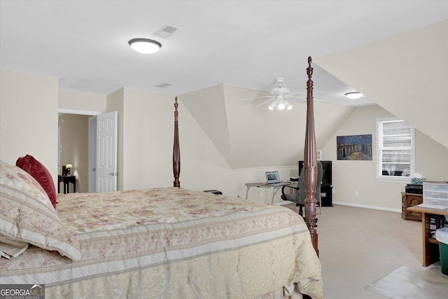 carpeted bedroom featuring lofted ceiling and baseboards