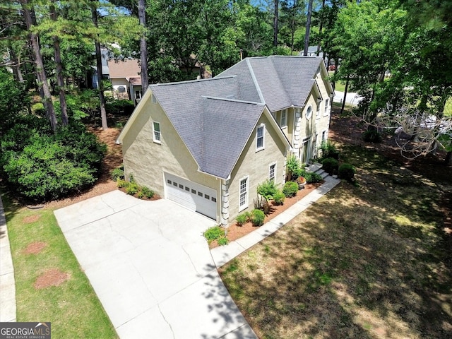 aerial view of property and surrounding area featuring a tree filled landscape