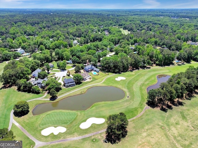 bird's eye view of a forest, a large body of water, and a local golf course