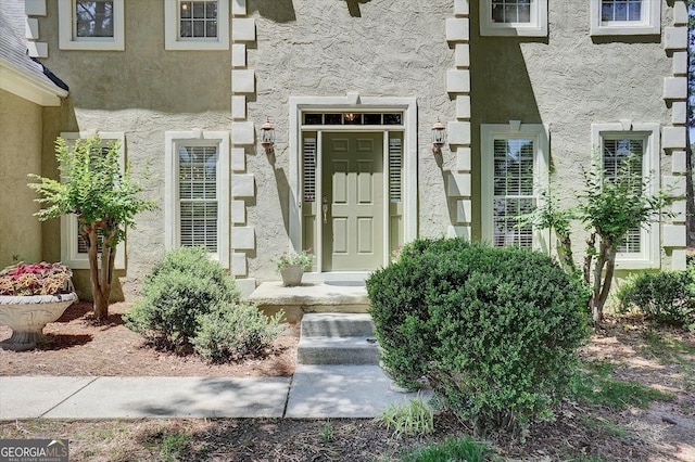 view of exterior entry featuring stucco siding