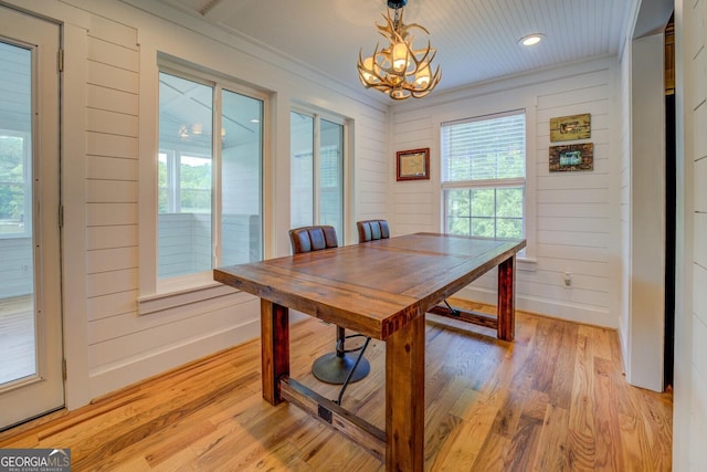 22 Waters Bridge Cir, Covington, GA 30014 - dining area with a chandelier, healthy amount of natural light, light wood-type flooring, recessed lighting, and wood walls