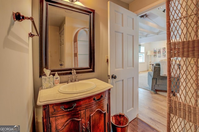 22 Waters Bridge Cir, Covington, GA 30014 - bathroom featuring wood finished floors, vanity, and beamed ceiling
