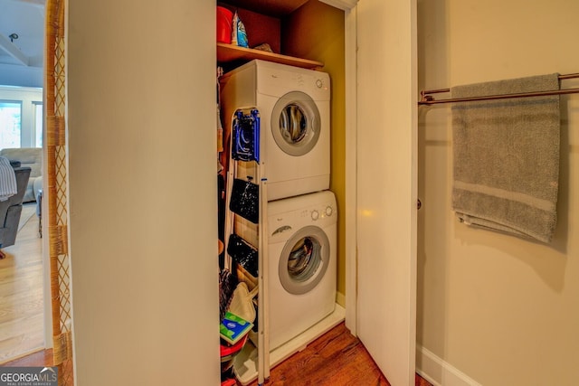 22 Waters Bridge Cir, Covington, GA 30014 - laundry room with stacked washer / drying machine and wood finished floors